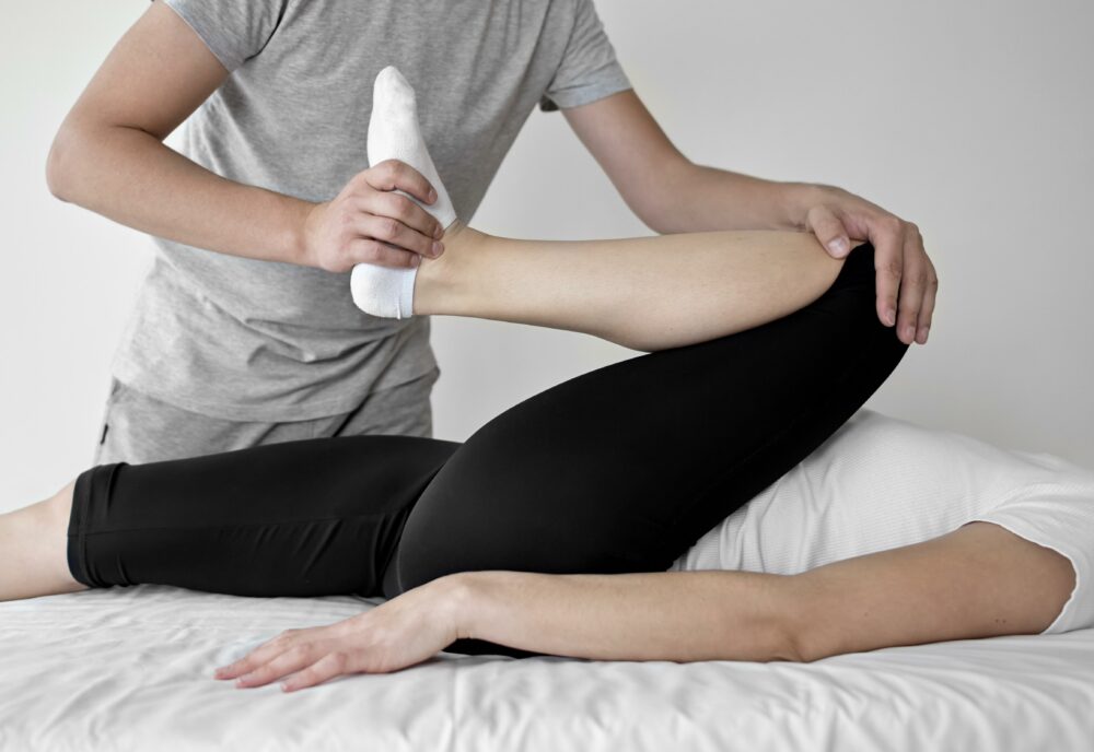 therapist undergoing physical therapy with female patient