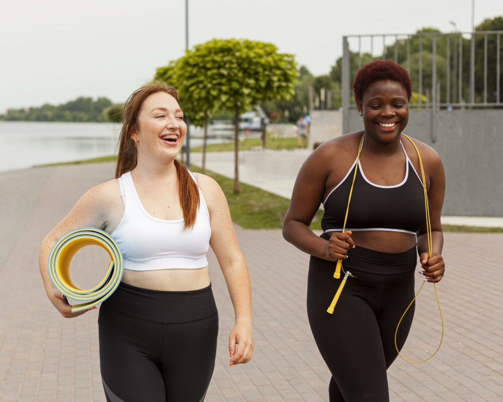 female friends outdoors trying exercise