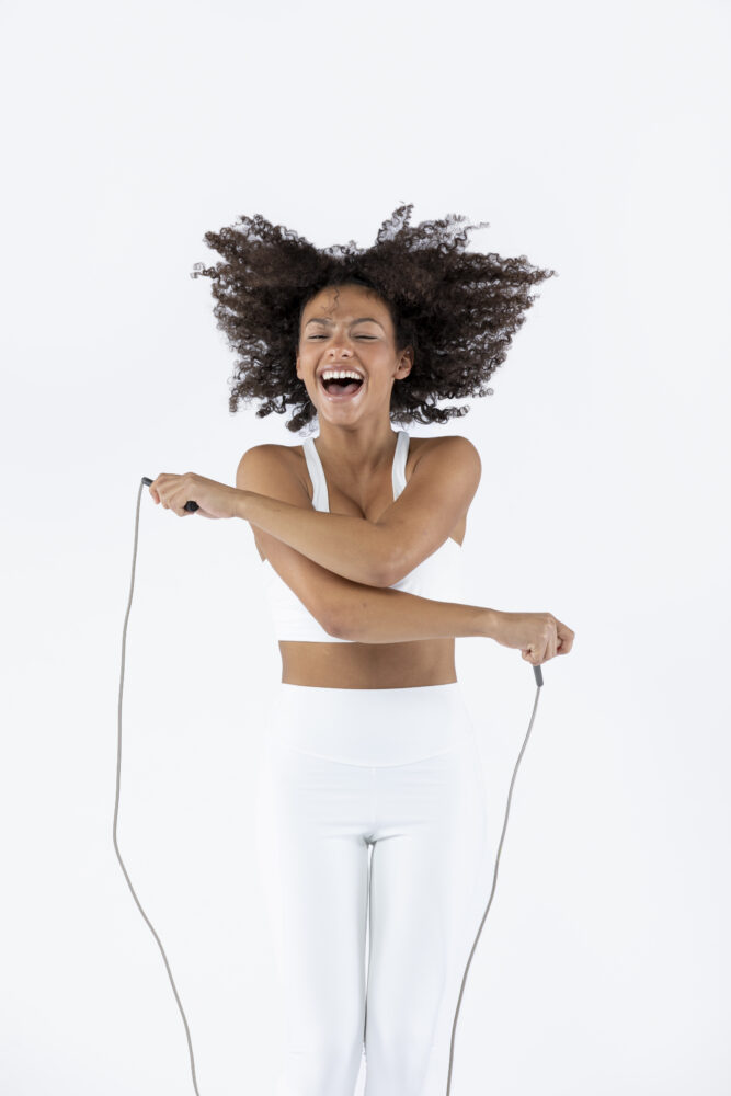 medium shot woman jumping rope